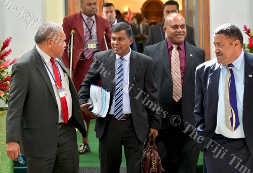 Governmengt MP Netani Rika (left) in discussion with Opposition MP Biman Prasad, Government MP Samuela Vunivalu and Opposition MP Ratu Suliano Matanitobua during a break in Parliament sitting yesterday. Picture: JOVESA NAISUA