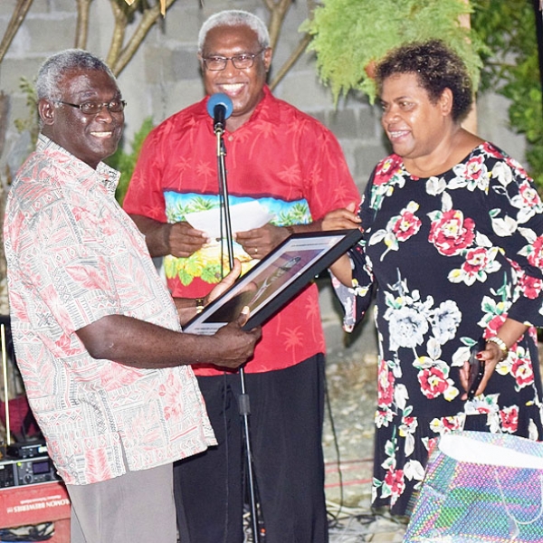 Caretaker Prime Minister Manasseh Sogavare receives a gift from his Secretary Dr Isom Rohorua and Executive Personal Secretary Suzie Wale