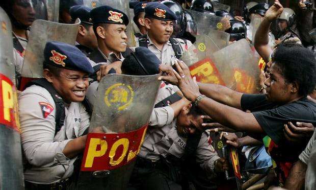  West Papuan activists clash with police guarding the office of a US mining company. On Tuesday, one person was reportedly killed by Indonesian police at a protest in Deiya regency. Photograph: Ed Wray/AP