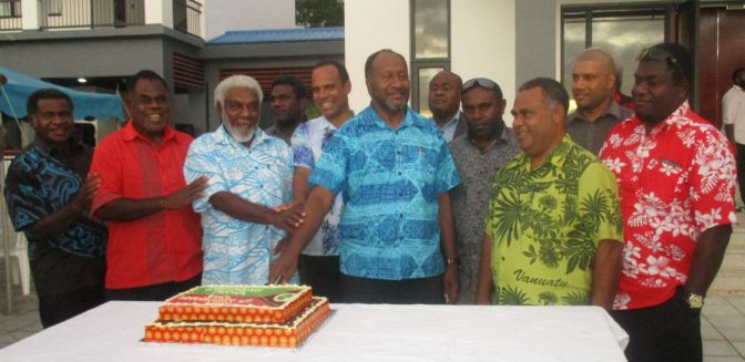 The Prime Minister and government ministers cut a cake to mark their two years in government.