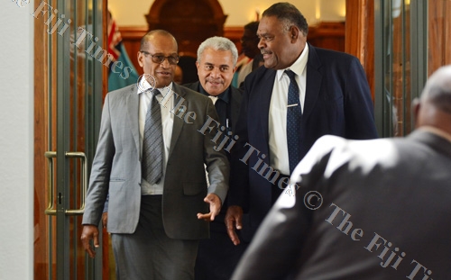 Minister for Employment, Productivity & Industrial Relations Jone Usamate (left) speaking with Opposition MP Mikaele Leawere and Government MP Mataiasi Nuimataiwalu at the parliament complex yesterday. Picture: JOVESA NAISUA